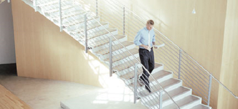 Image of a man walking down a professional looking office stairway